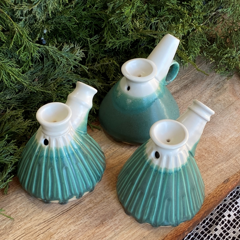 A group of three conical bubblers with teal and white glaze