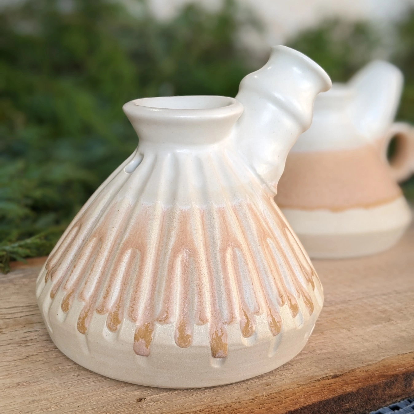 Pink bubbler with vertical carved lines and a drippy glaze